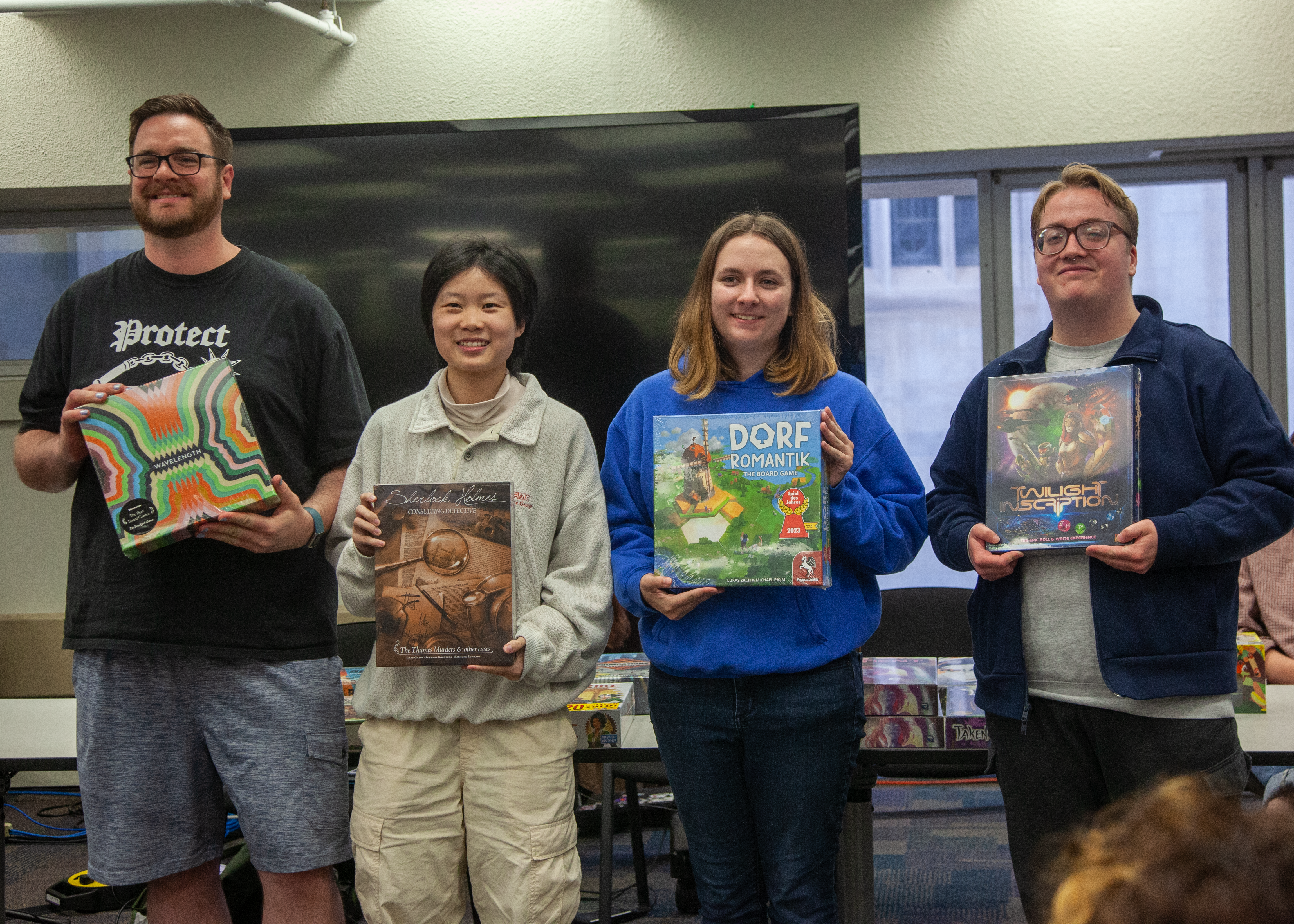 Paperworkx team members holding board games after winning the Narrative Design award